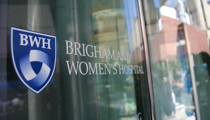 The Brigham and Women’s Hospital logo shield on a window in the Longwood Medical Area, Boston, MA. 
