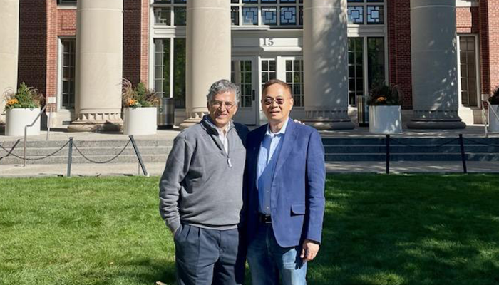 Gene Lay and Vijay Kuchroo in front of building