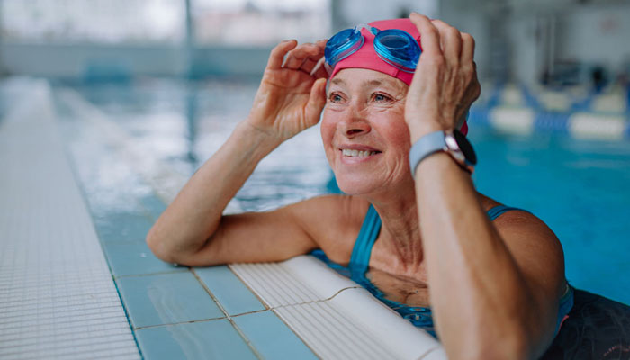 Senior woman smiling while in indoor pool
