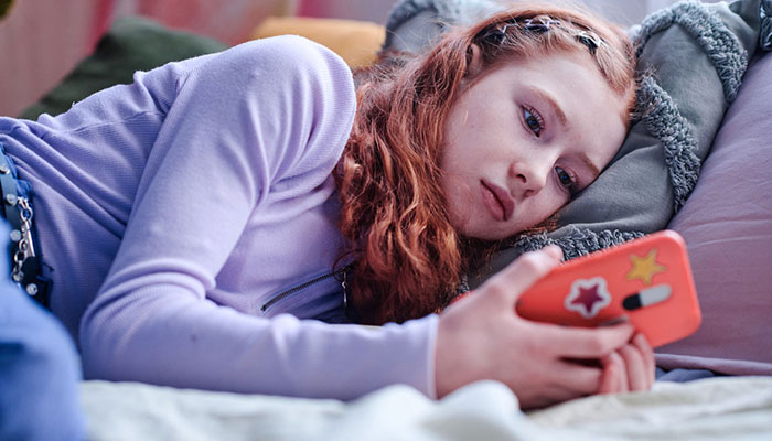 Teenage girl looking at cell phone