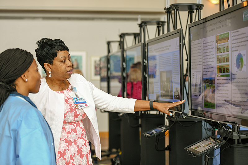 Nadia Raymond (right) discusses her study with Sandra Parent.