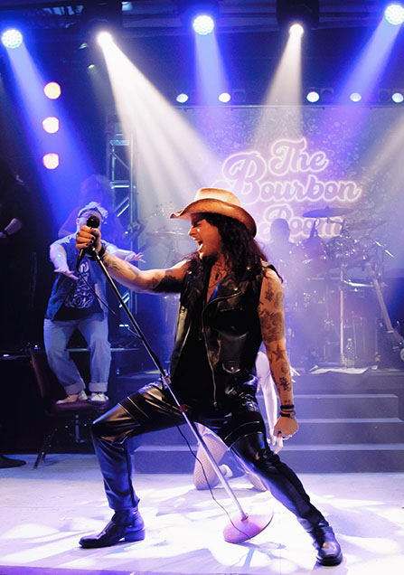 Gavin Davis performing on stage in Rock of Ages