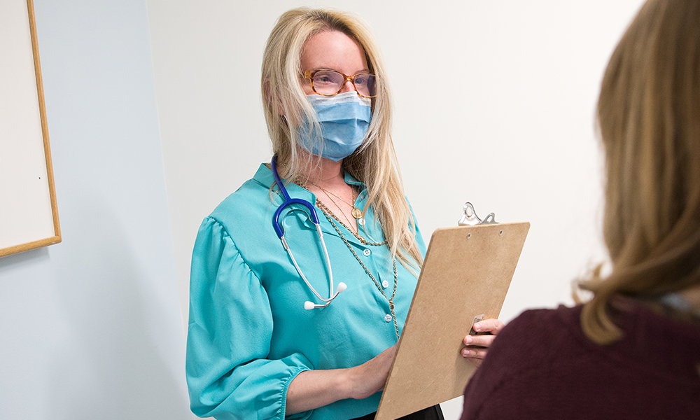 female clinician talking to patient