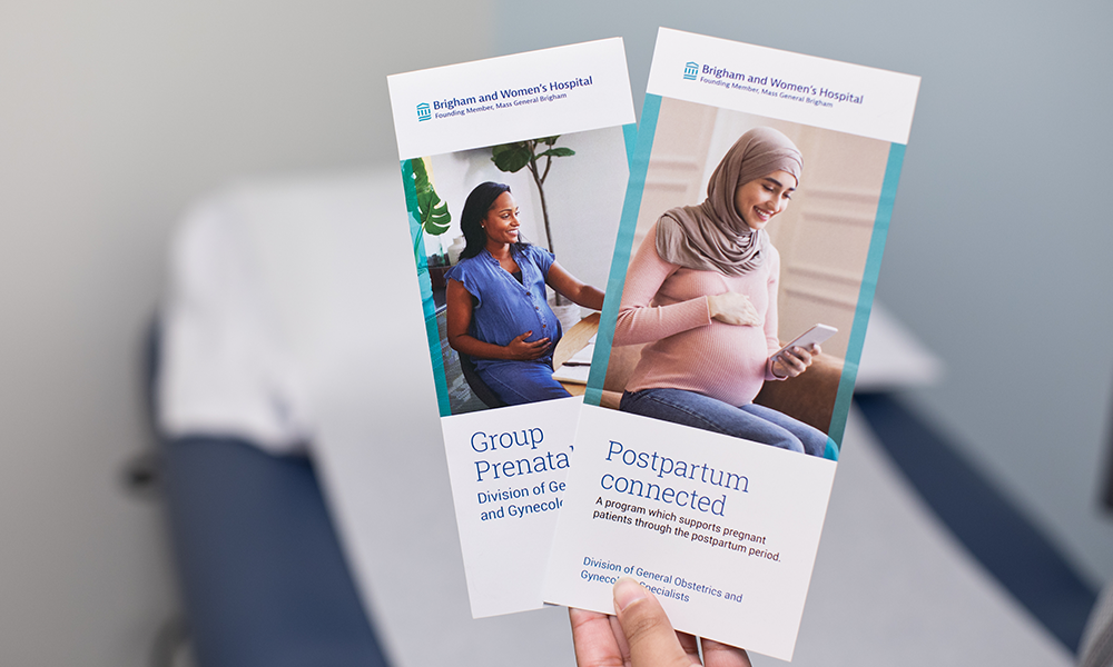 person hold brochures for prenatal group and postpartum connected