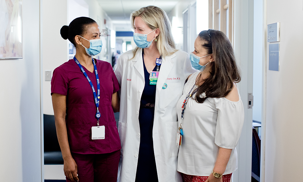 three female members of the care team in hallway