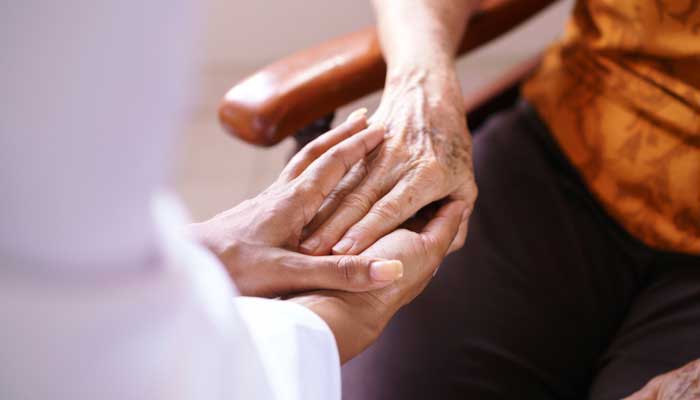 This is a photo a physician is examining the hand of a patient with rheumatoid arthritis. 