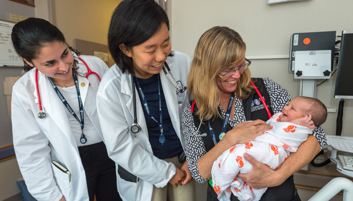 Three female doctors with a newborn