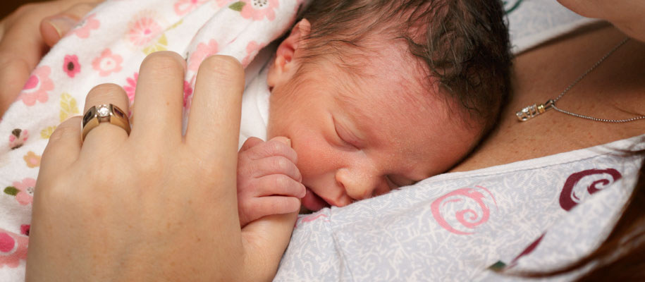 Newborn Baby Cuddling with Mom