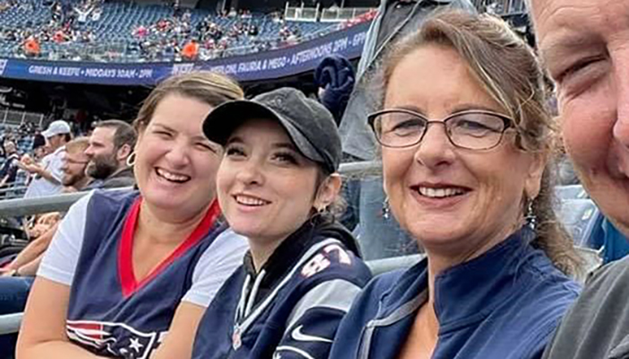 Jaclyn Zajac (center) with two members of her family at a Patriots game