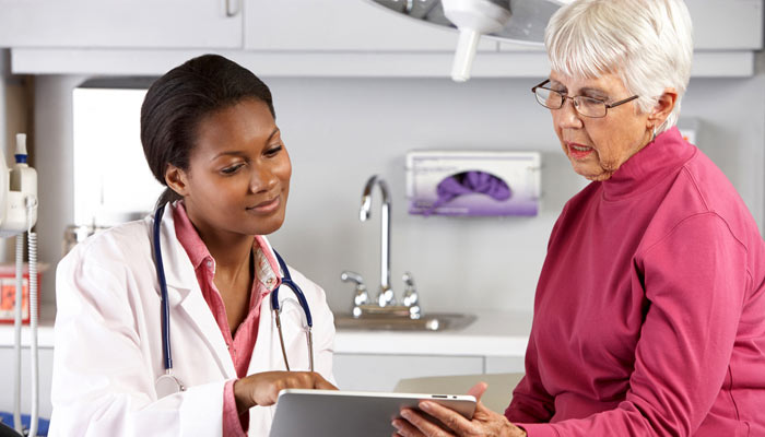 female doctor consulting with older female patient