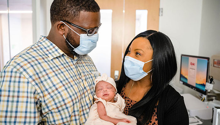 Kenyatta Coleman, pictured in the Brigham NICU with husband Derek and baby, Denver